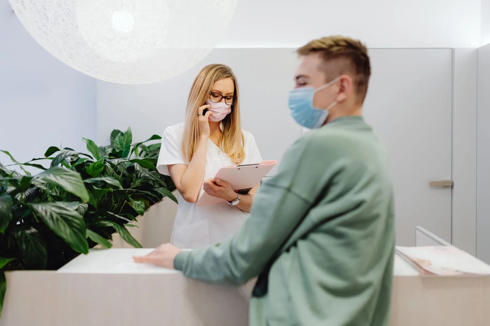 Healthcare CRM marketing integration: a clinic receptionist working at a computer
