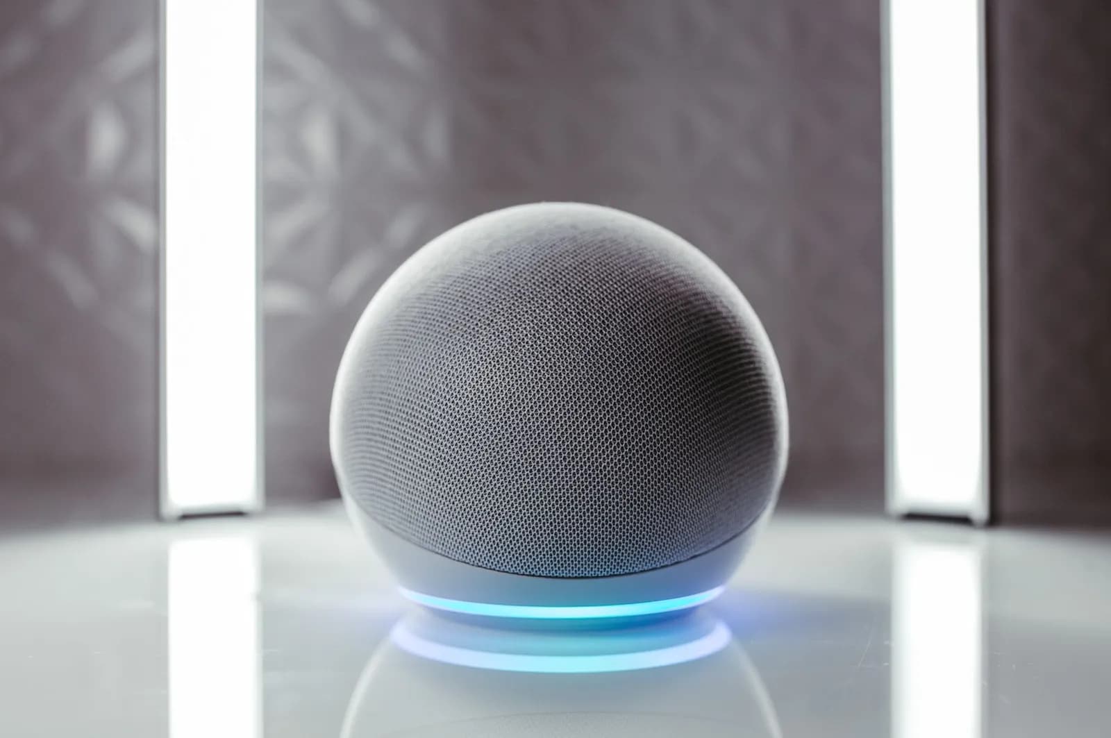 Close-up of a spherical smart speaker with illuminated base, perfect for modern interiors.
