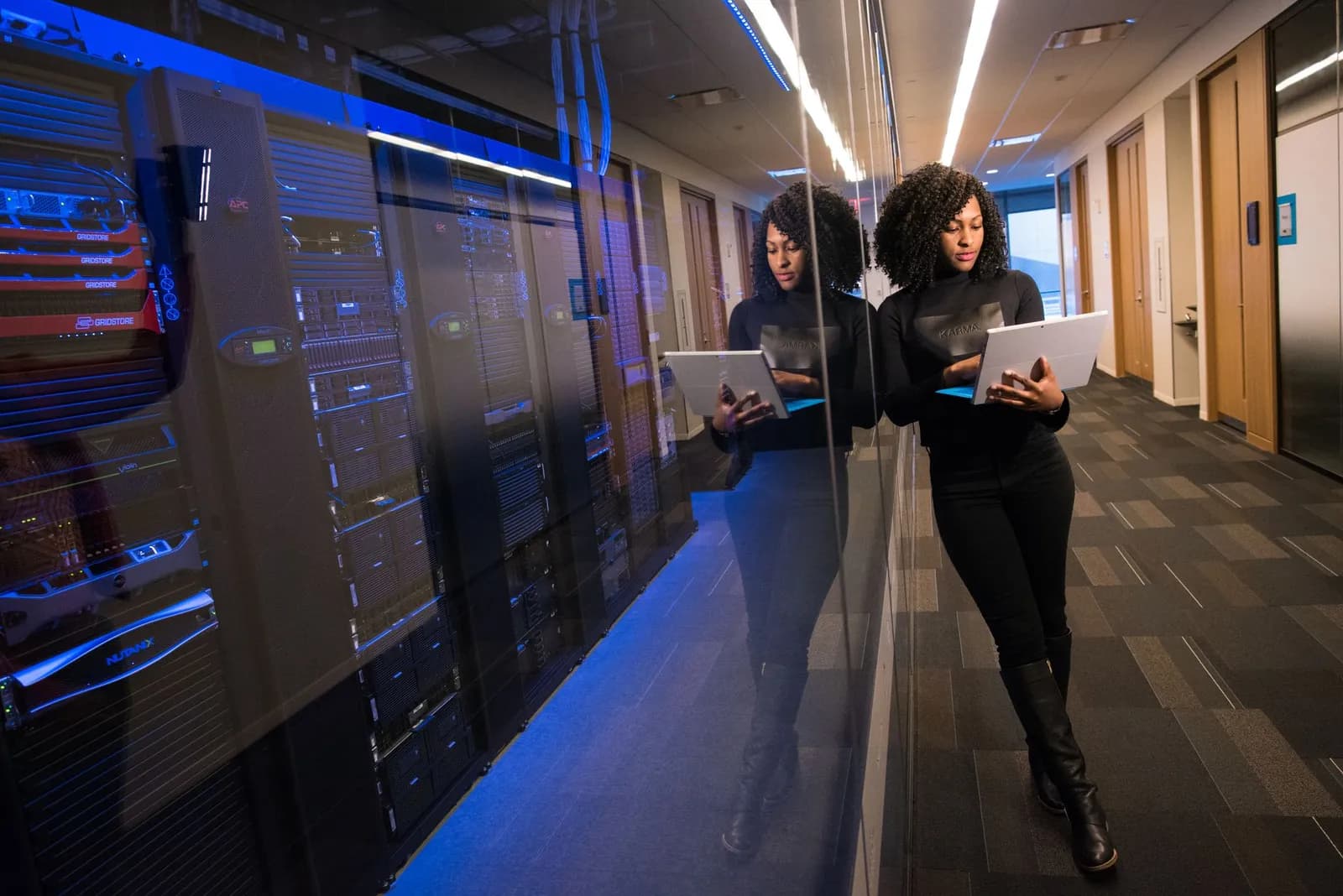 HIPAA compliant cloud hosting: an engineer working among data center server racks