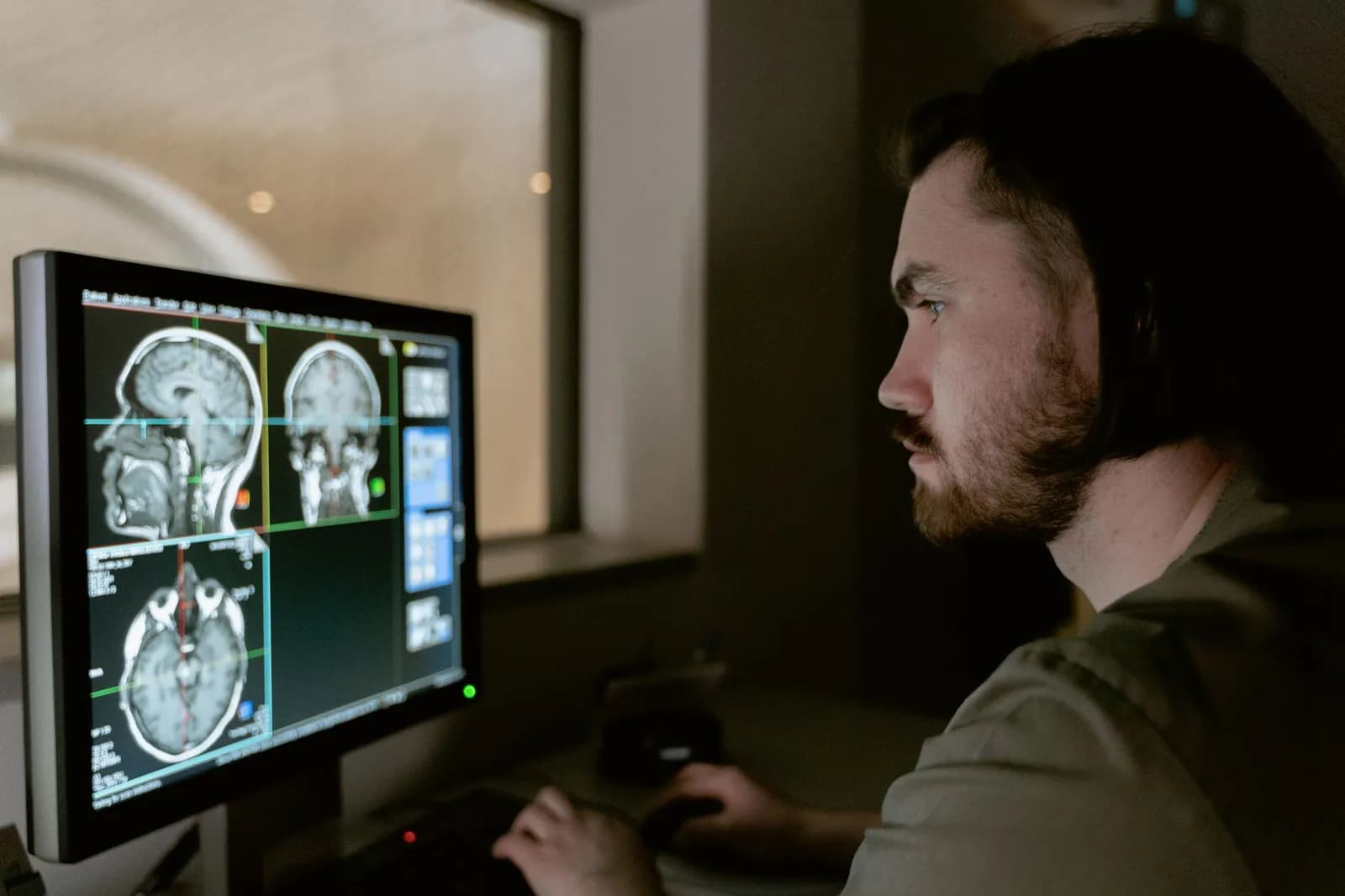 Medical image analysis software in use: a radiologist reviewing scans on a monitor