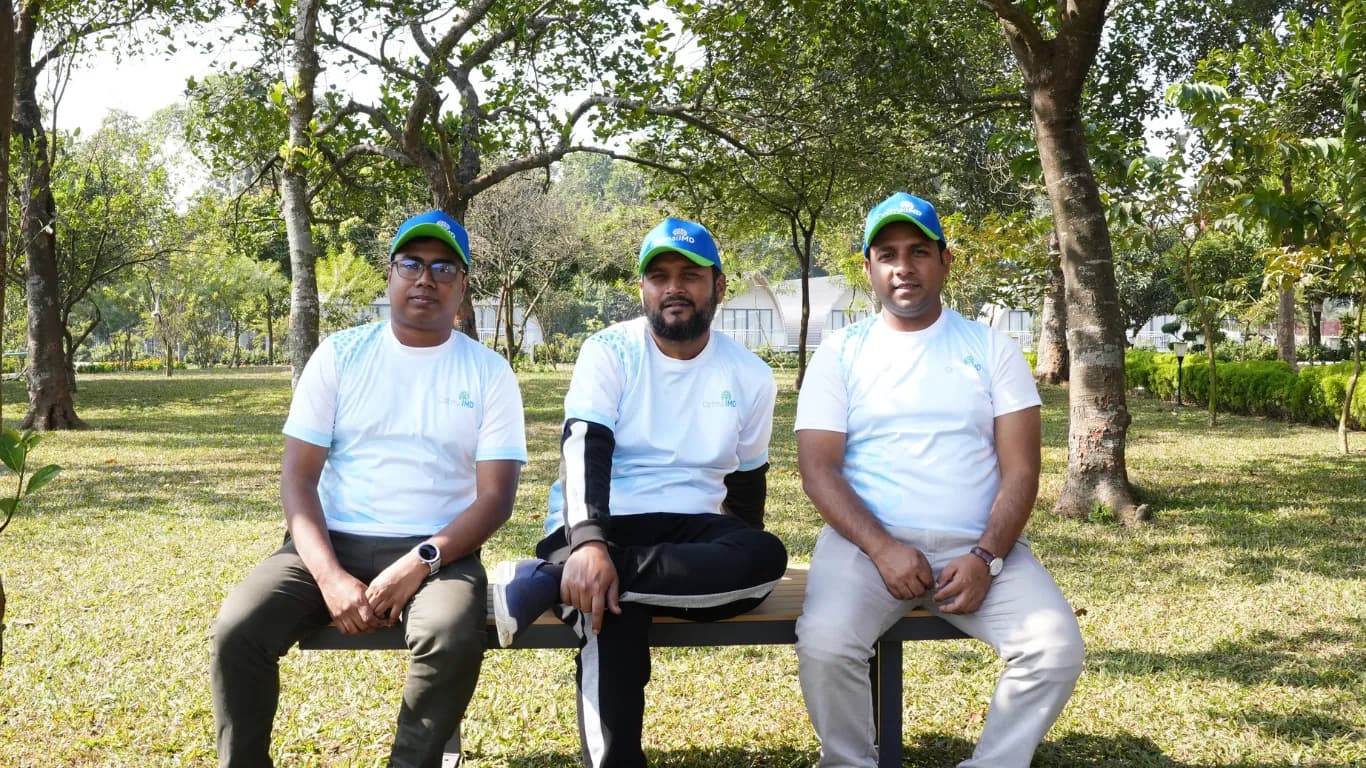 Team members sitting on a park bench
