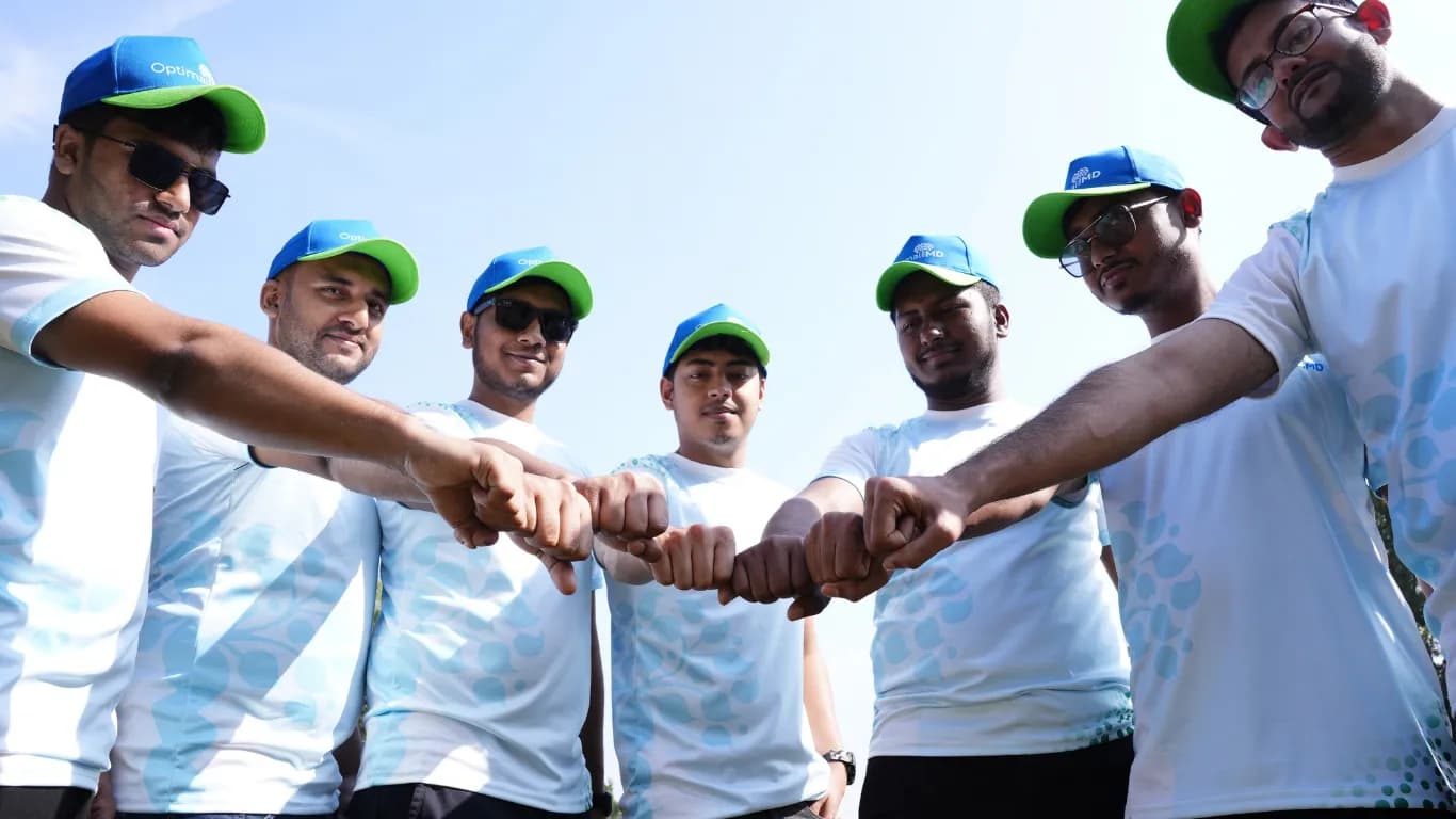 Team fist bump in matching white tees