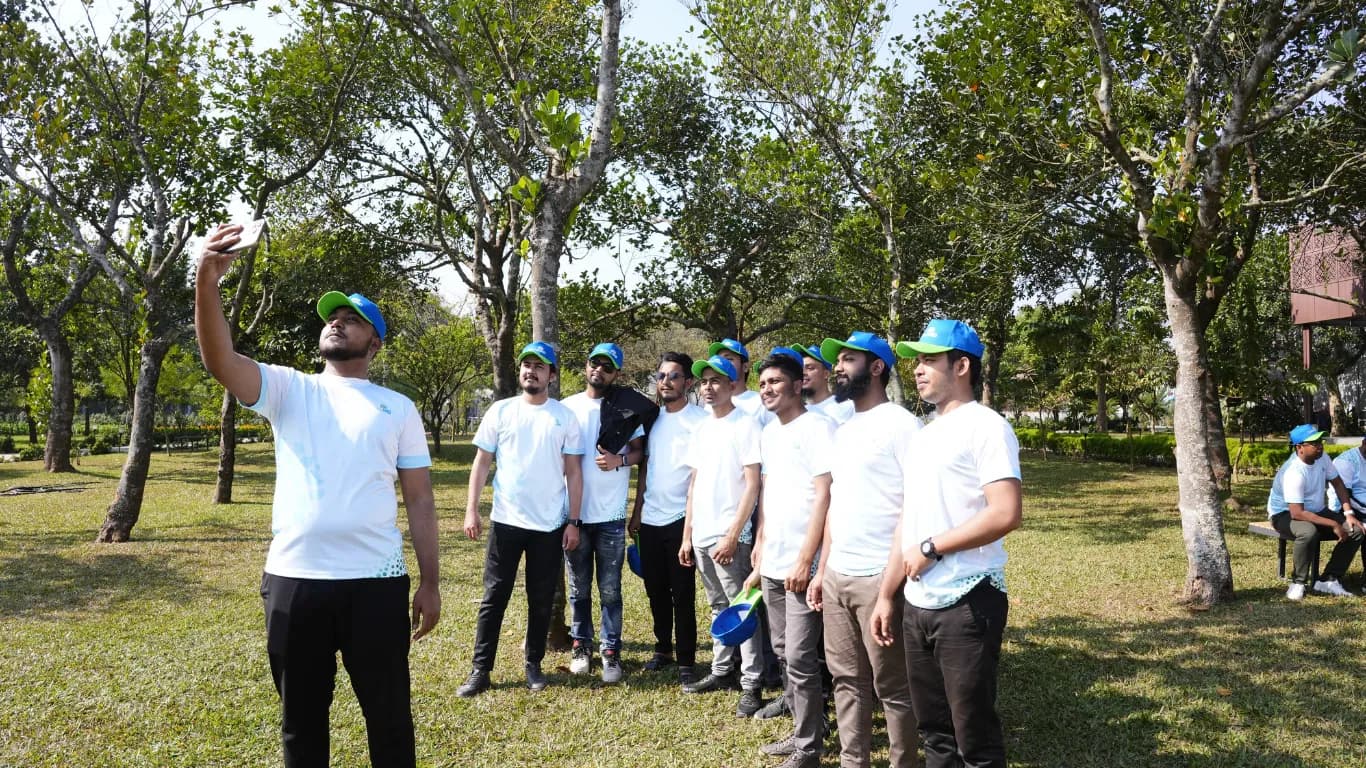 Team taking a group selfie in the park