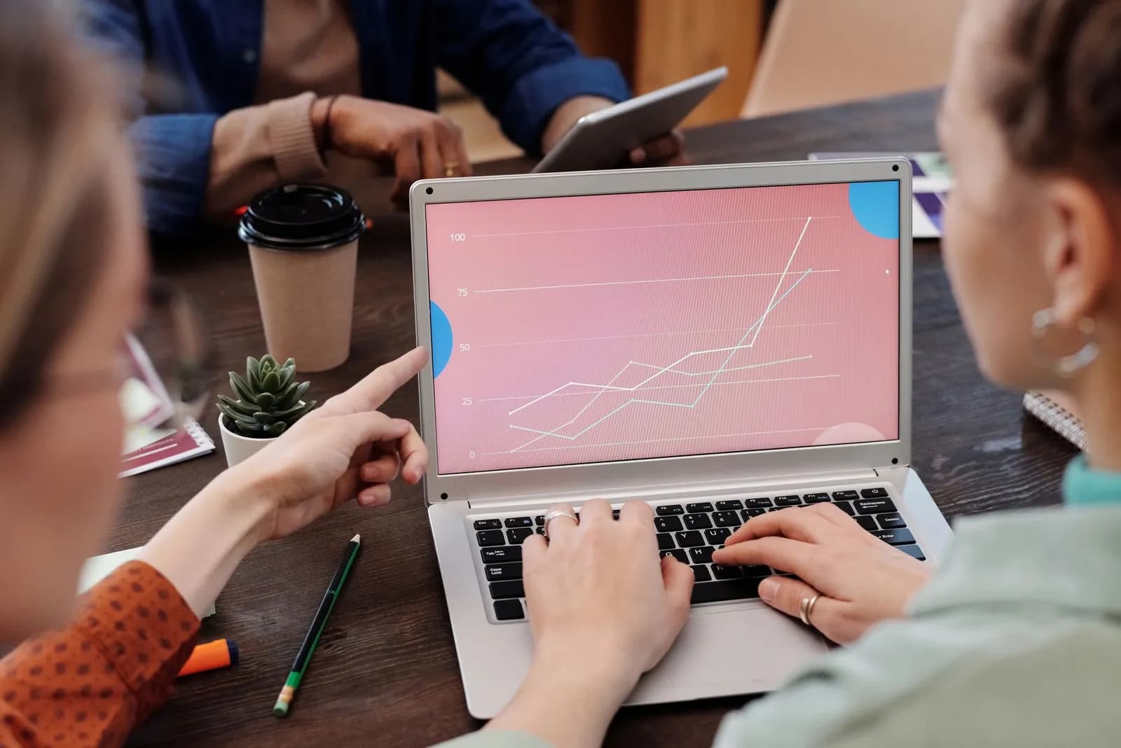CRM data migration: a small team reviewing customer records on a laptop