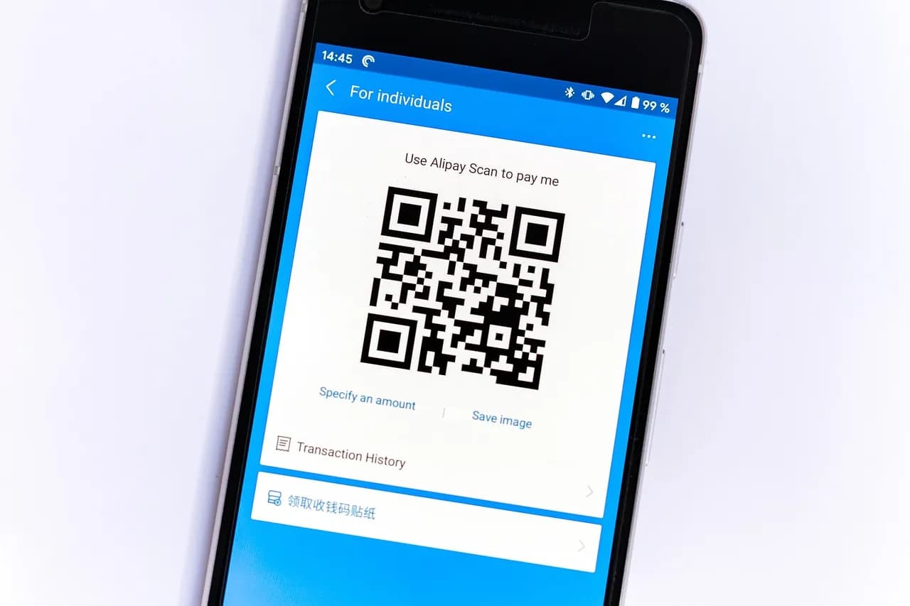 Smartphone displaying cryptocurrency graph alongside bitcoin coins and eyeglasses.