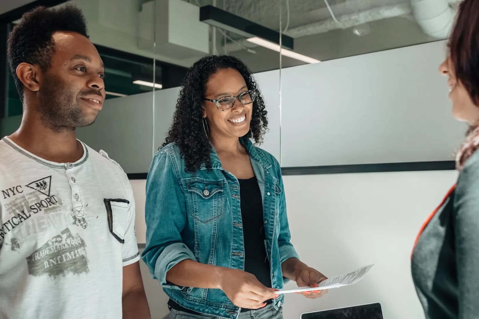 A happy couple consulting with a social worker in a modern office setting.
