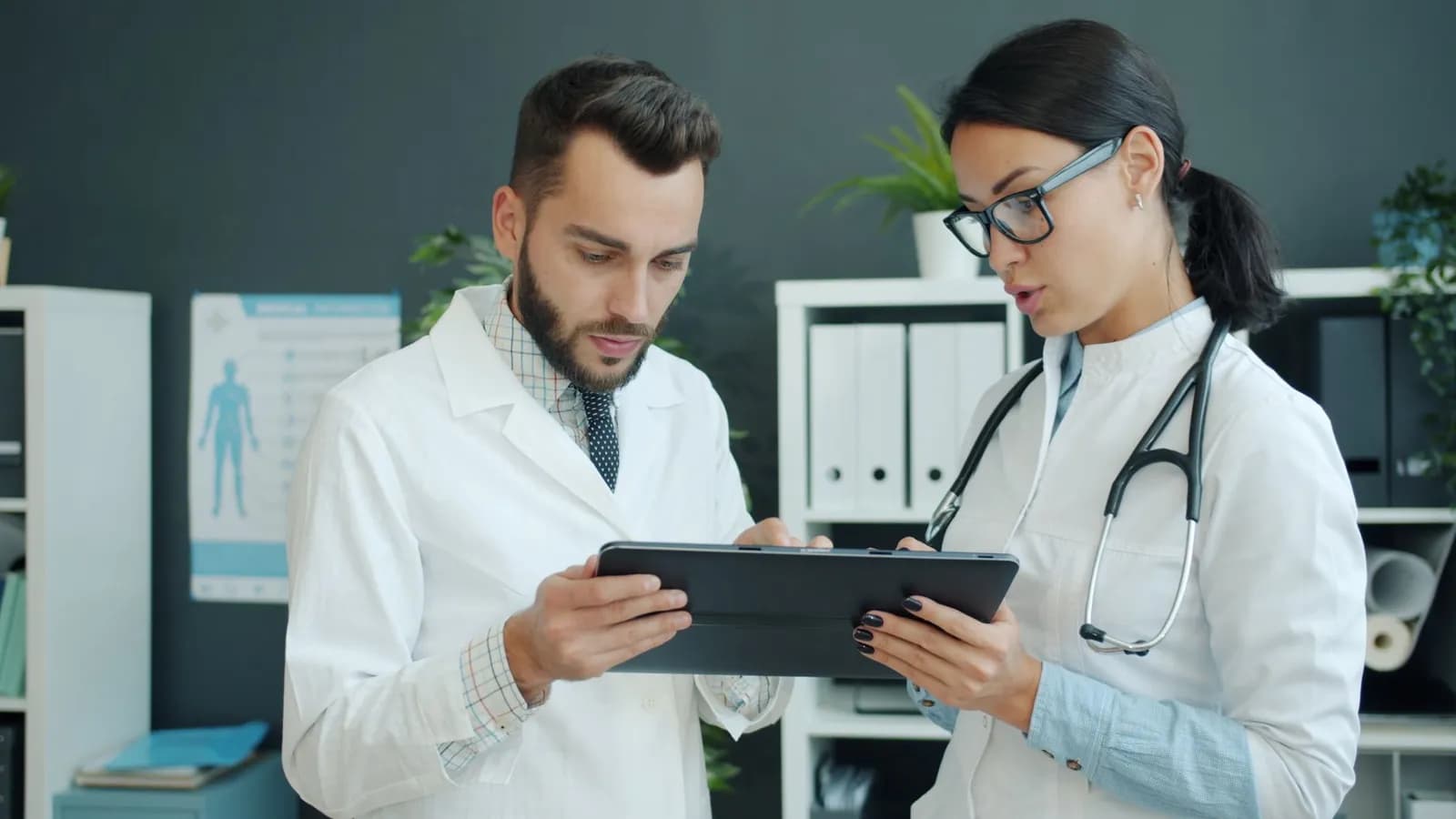 Healthcare interoperability solutions: a doctor reviewing patient records on a tablet