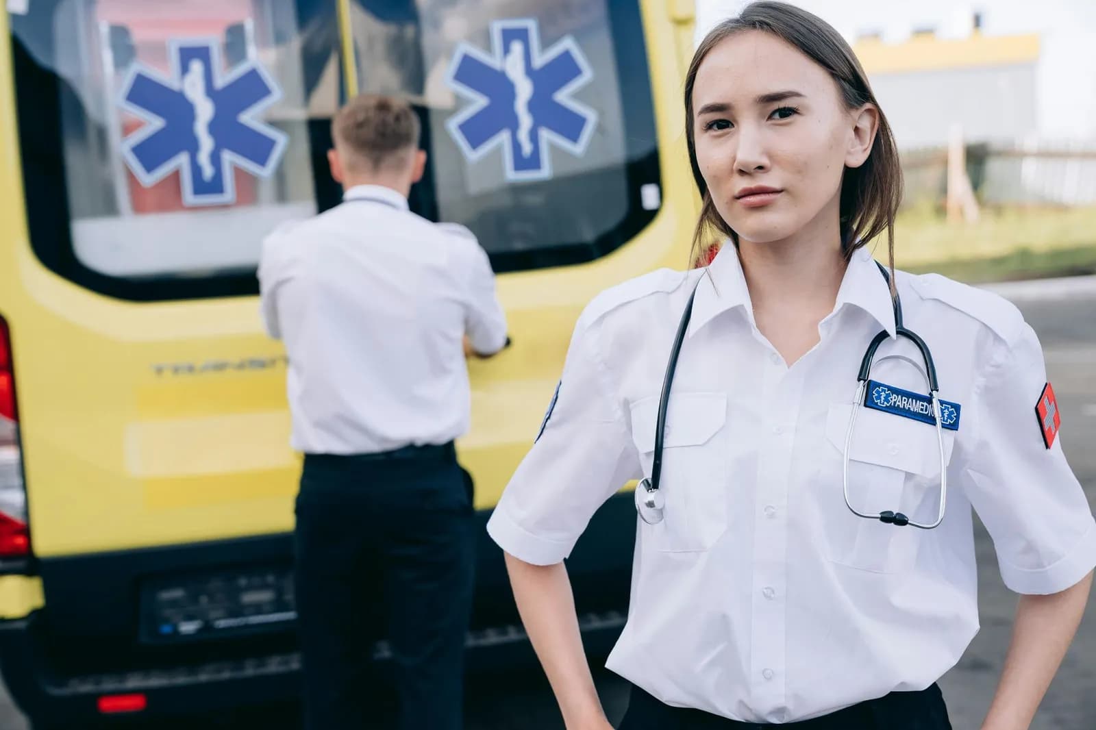 Paramedic team ready for emergency response beside ambulance.