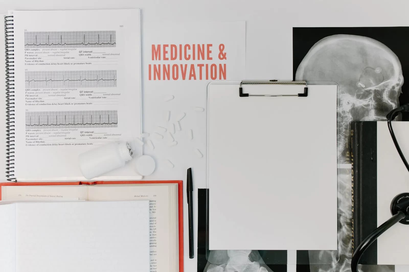 Flat lay of medical documents and equipment emphasizing innovation.