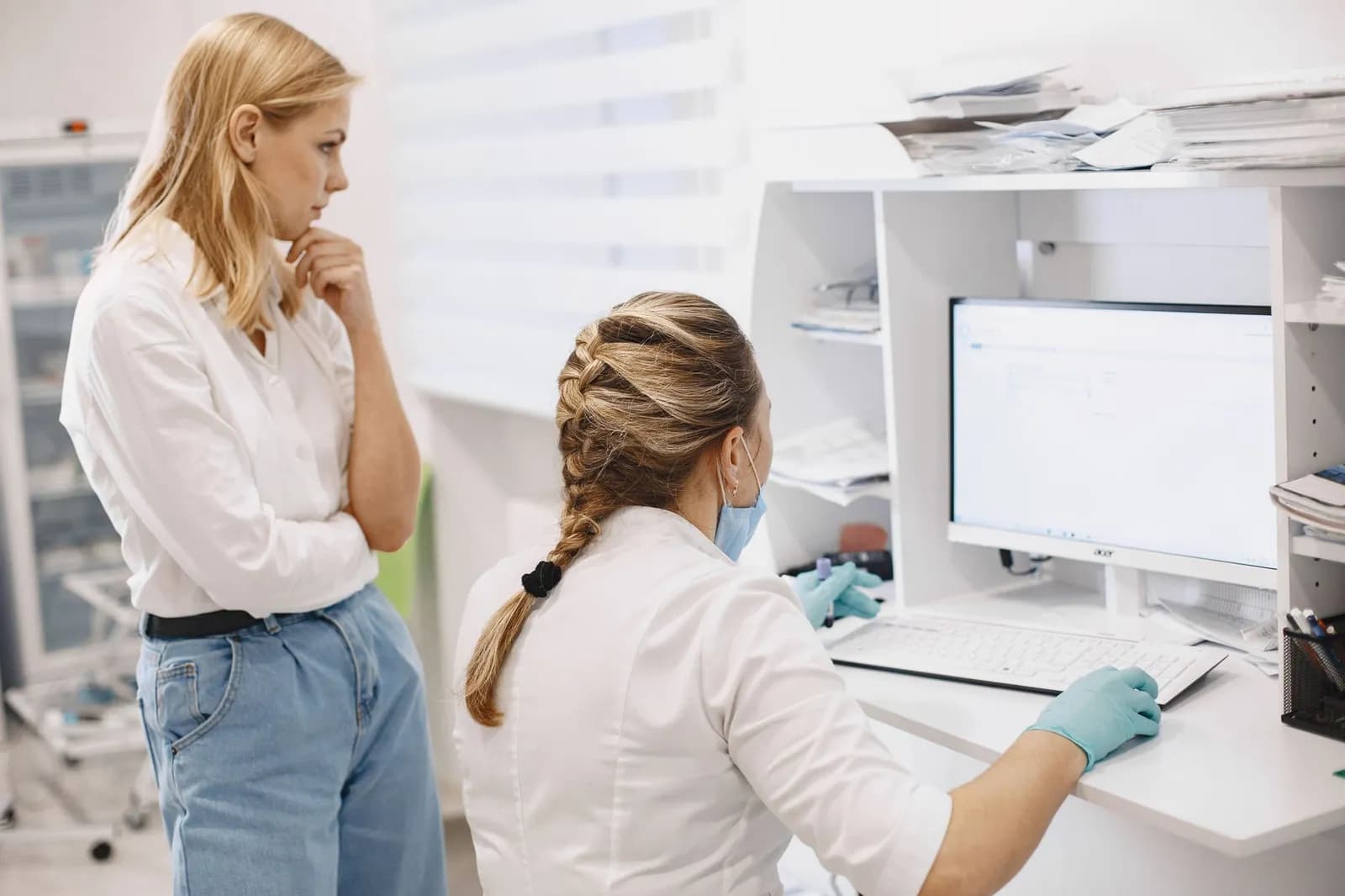 Healthcare RCM software development: a medical billing specialist reviewing claims at a desk