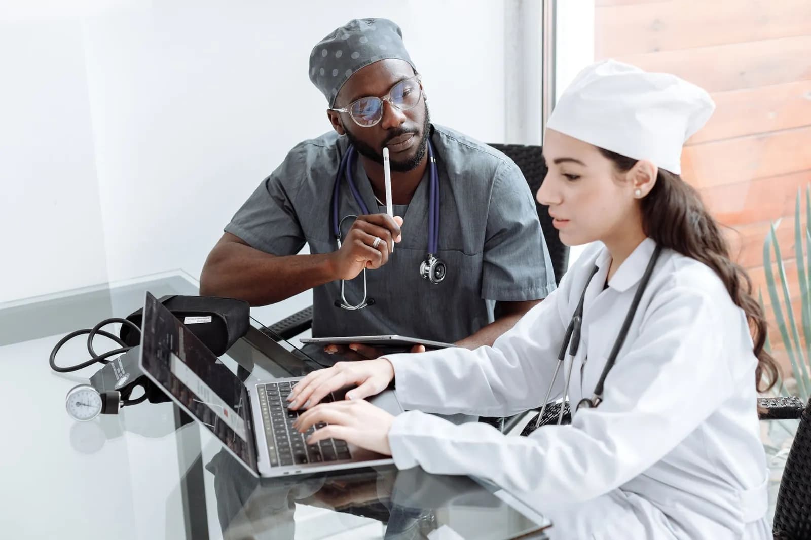 Healthcare SaaS platform development: a clinician using a tablet in a clinic