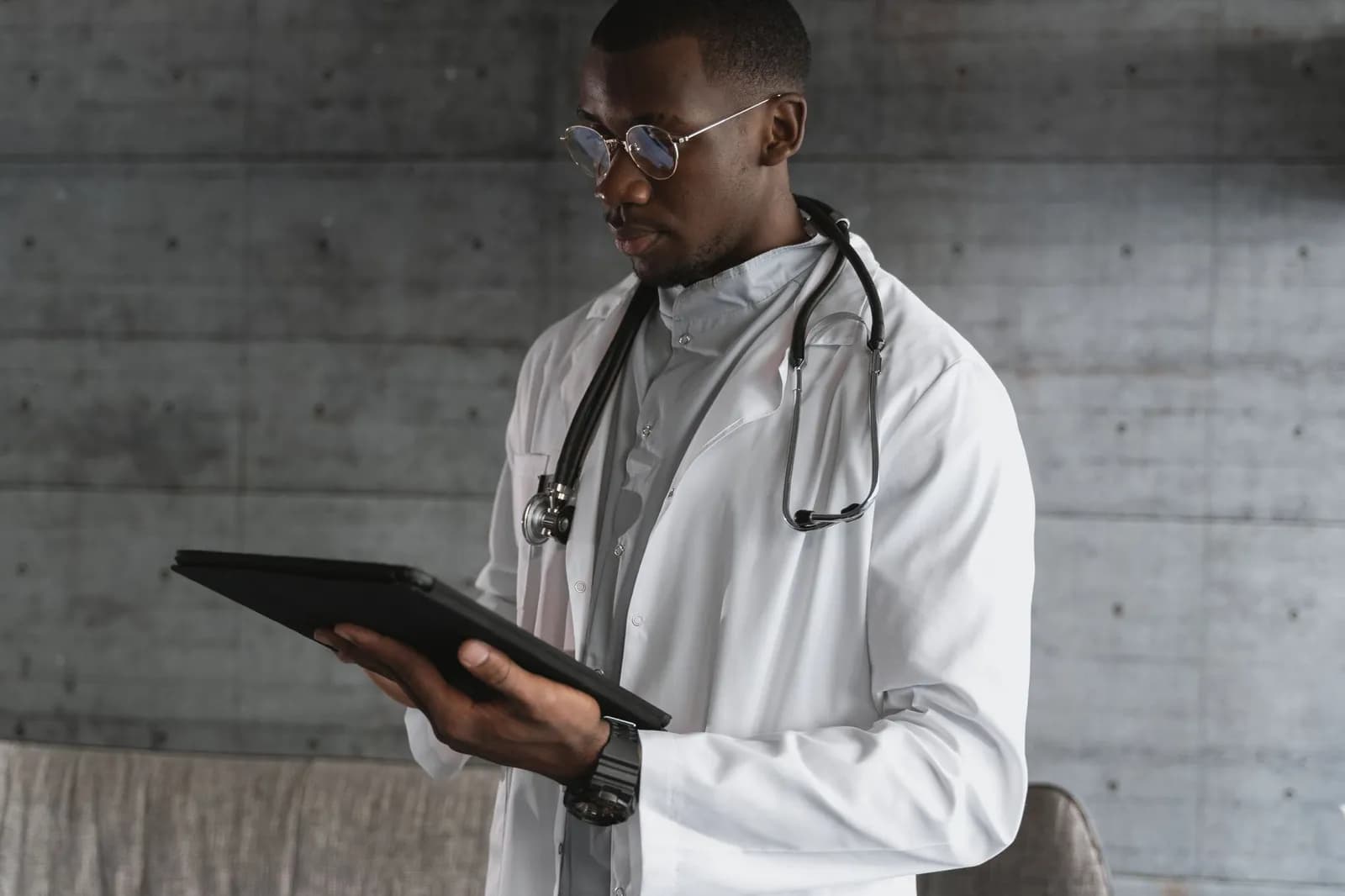 Healthcare software development cost: a doctor reviewing patient records on a tablet