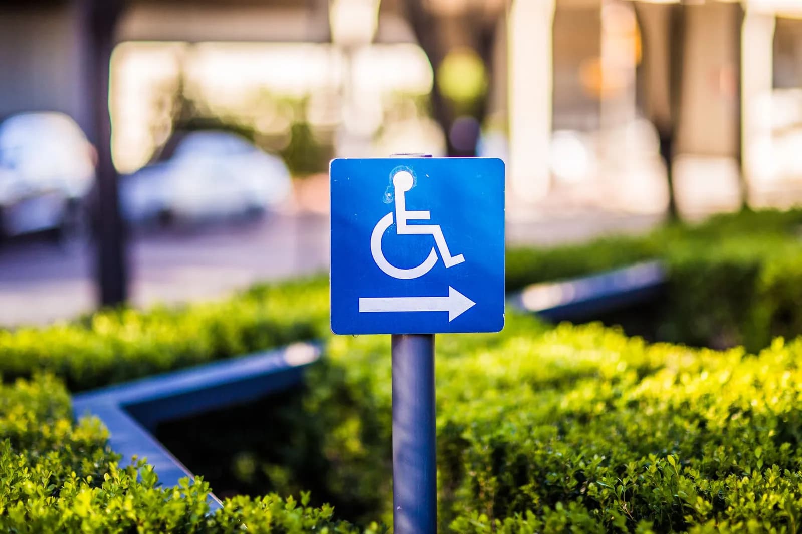 A faded disabled parking symbol painted on asphalt pavement, highlighting accessibility.