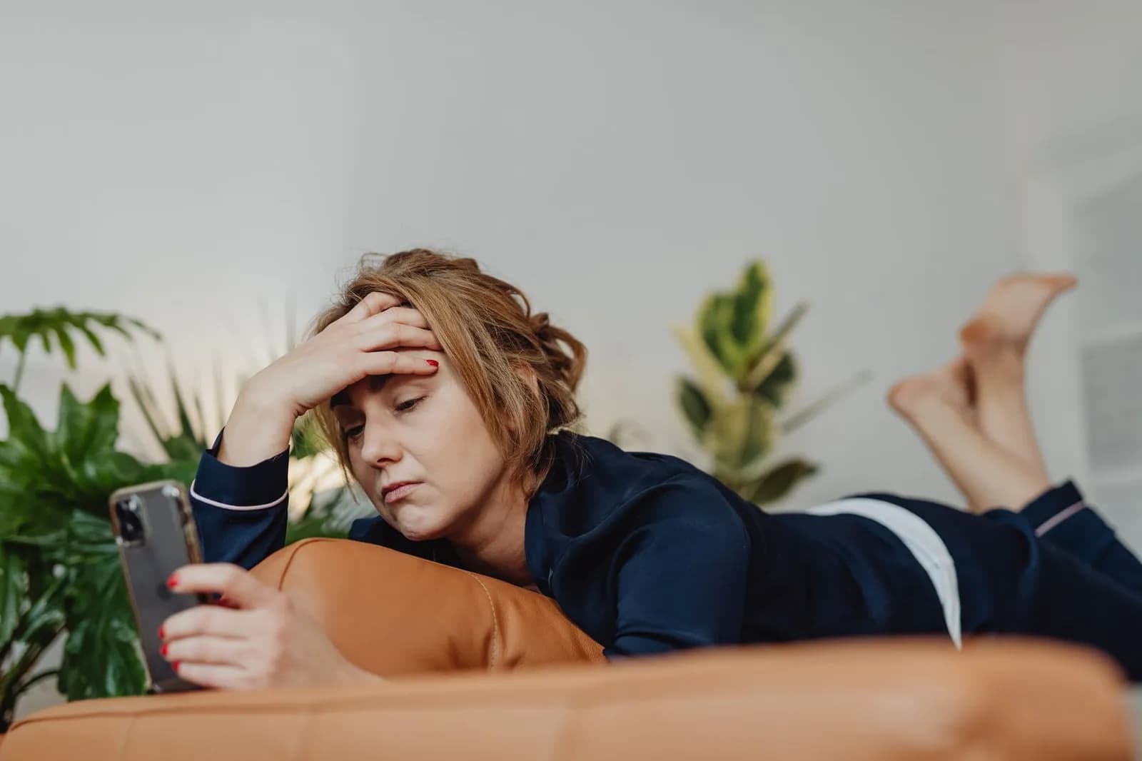 Mental health app development: a person using a wellness app on their phone at home