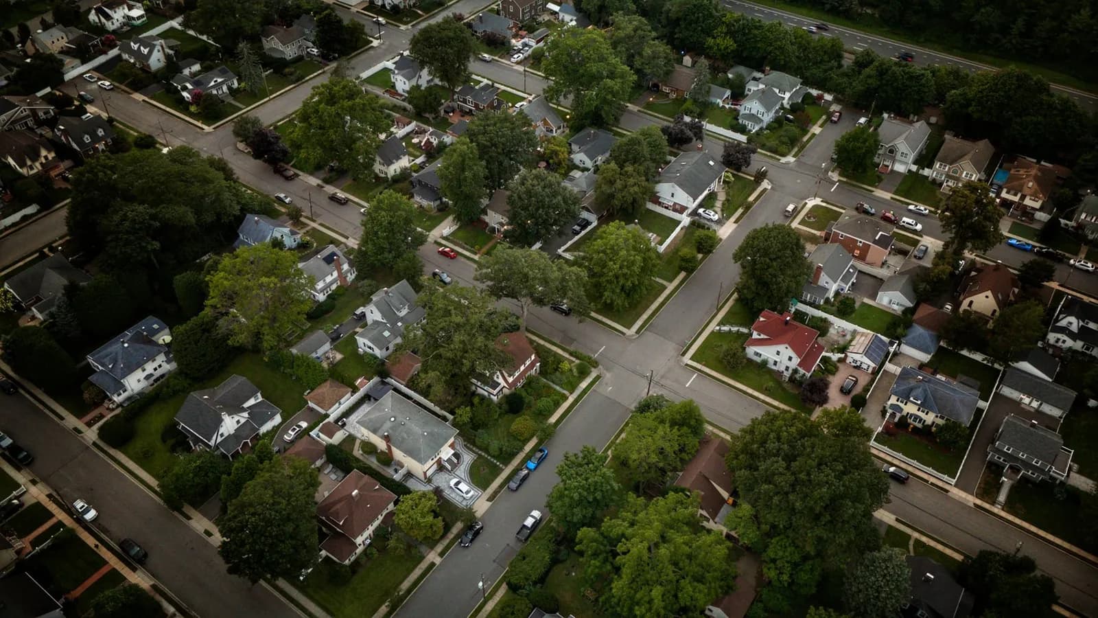 Aerial view showcasing a residential neighborhood in Herriman, Utah with modern architecture and green lawns.