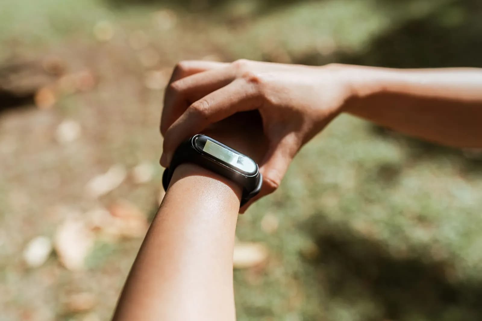 Wearable health device software: a person checking a smartwatch reading on their phone