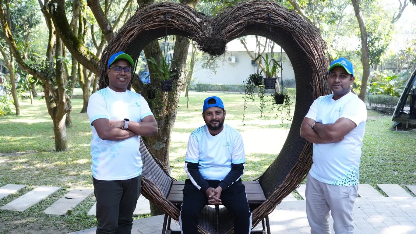 Three team members posing at the heart swing
