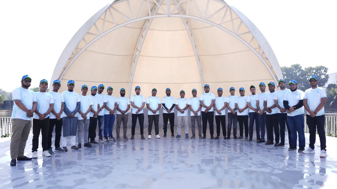 Team lined up in front of the white dome