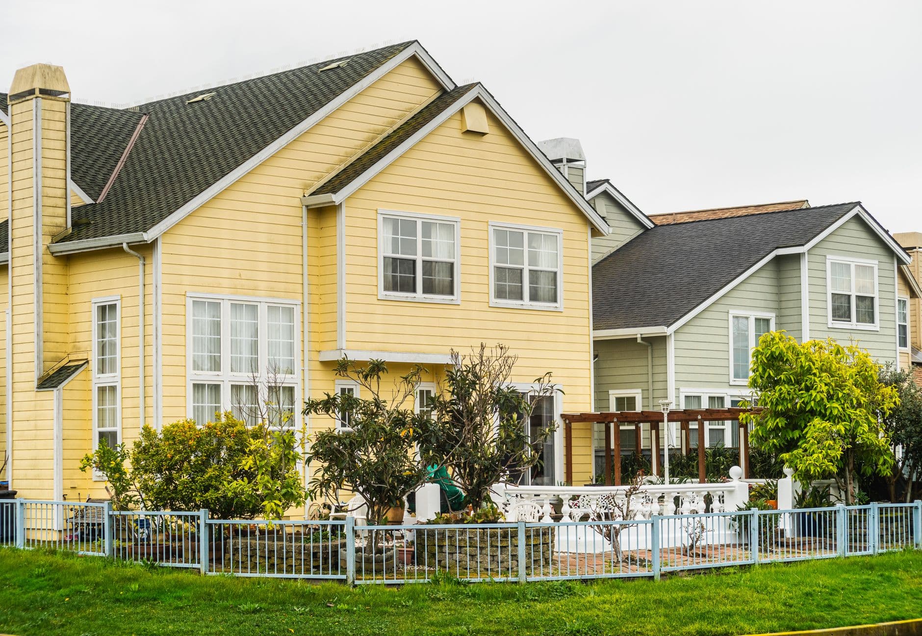 Bright suburban houses with gardens and fences, perfect for family living.