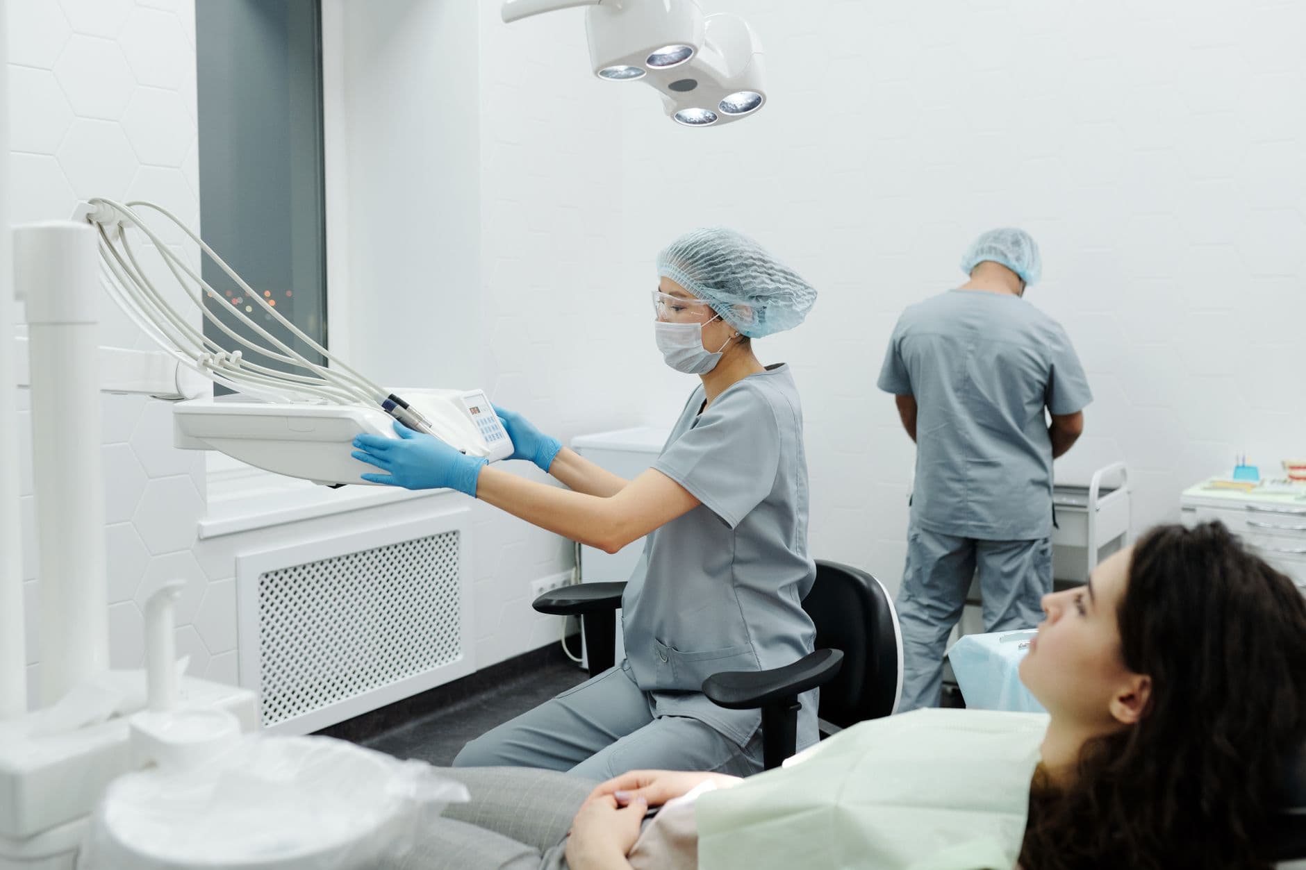 Dental professionals in action within a modern clinic, treating a patient.