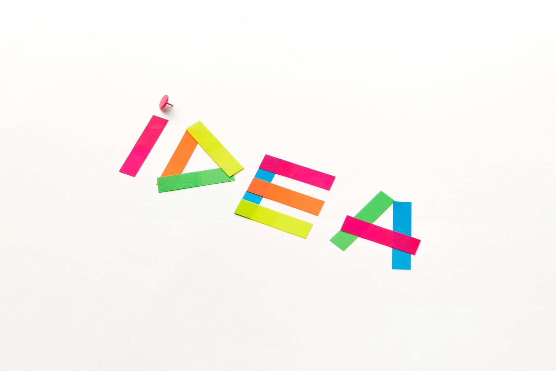 Creative concept with colorful paper cutouts spelling 'IDEA' against a white background.
