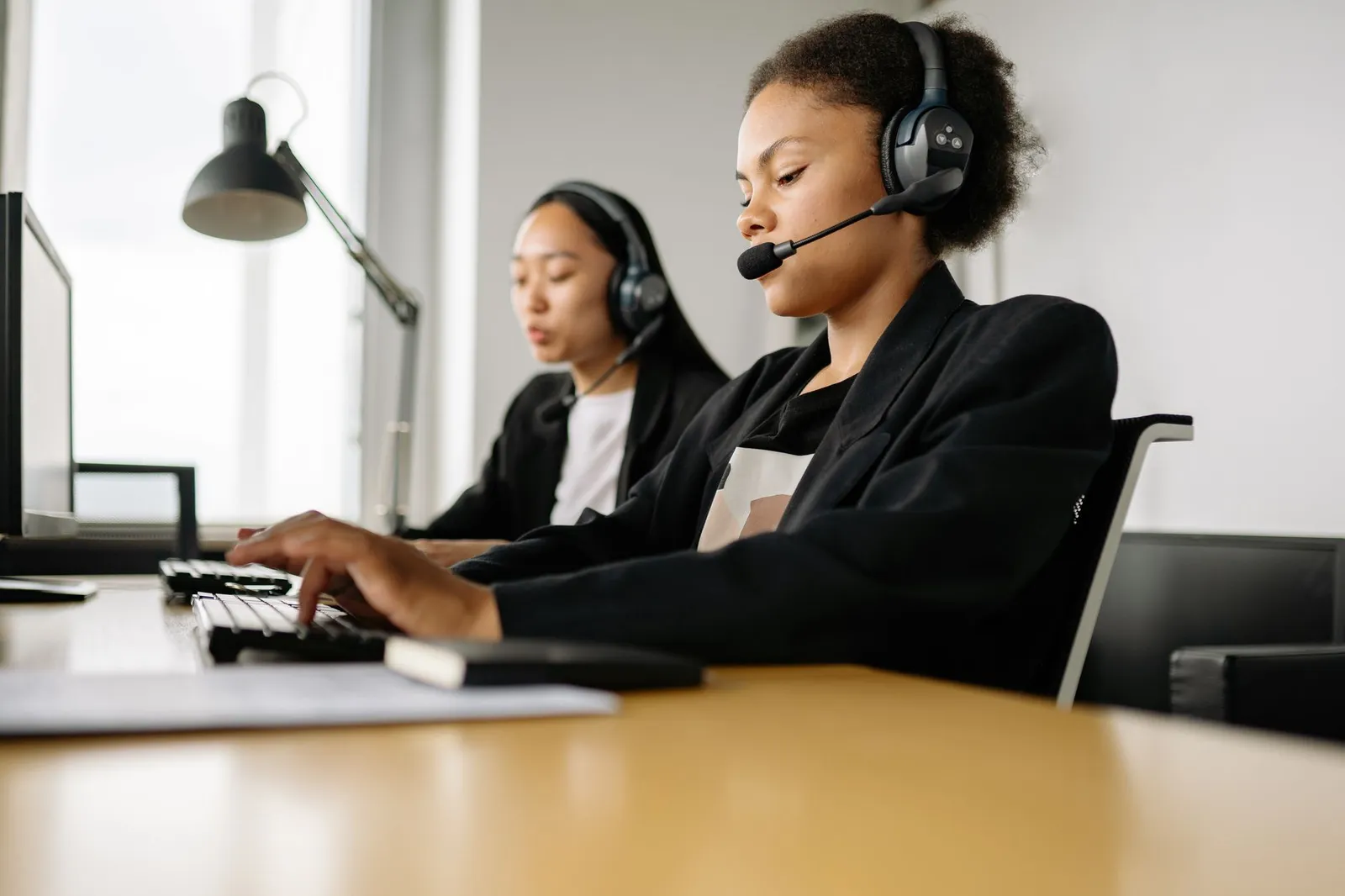 Dedicated call center agents working diligently at their desks in an office.