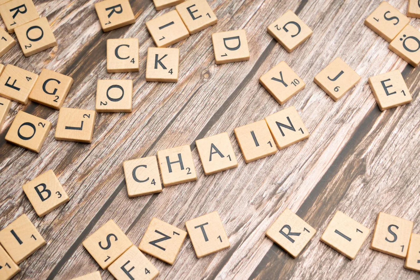 A collection of wooden letter tiles forming words on a rustic wooden surface. Ideal for word game concepts.