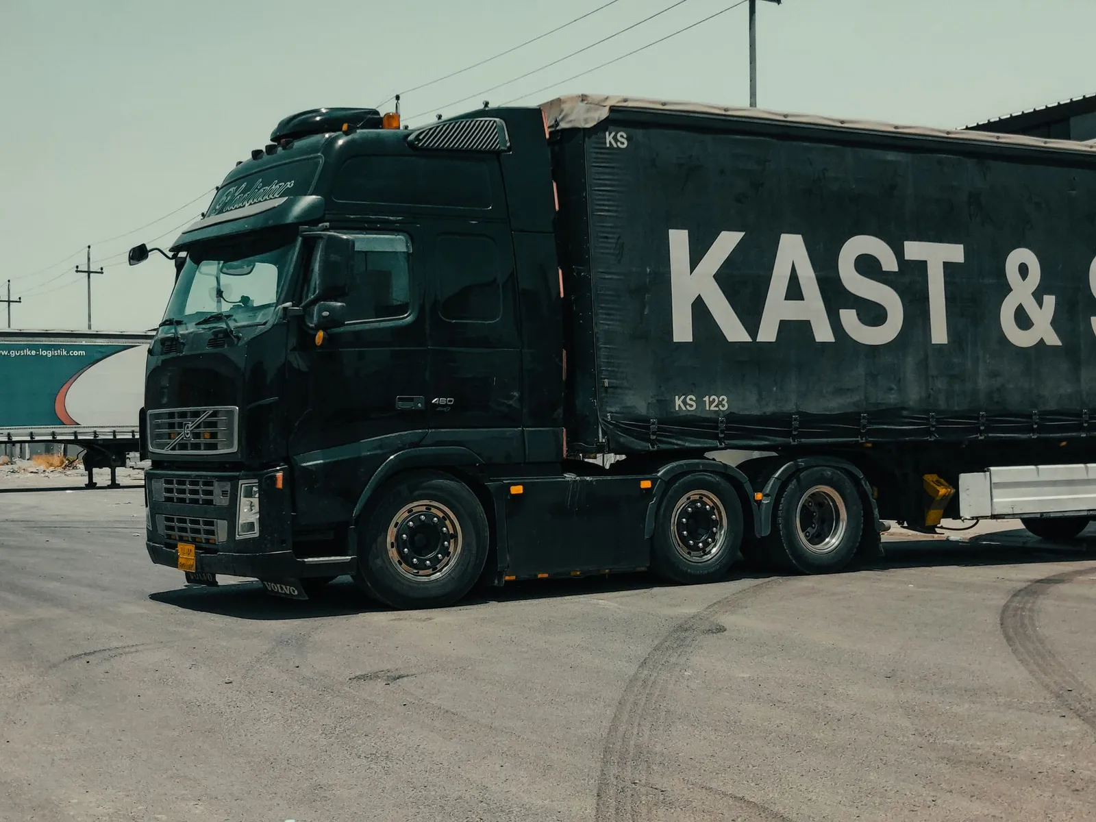 A large industrial truck parked in an urban setting, showcasing transportation industry visuals.