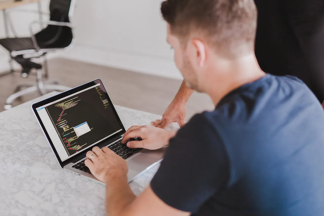Vibe coding healthcare app prototype being reviewed by a developer on a laptop